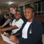 Dudu and Godslove Gumbi in art class with Samantha Botha, the school's art teacher.