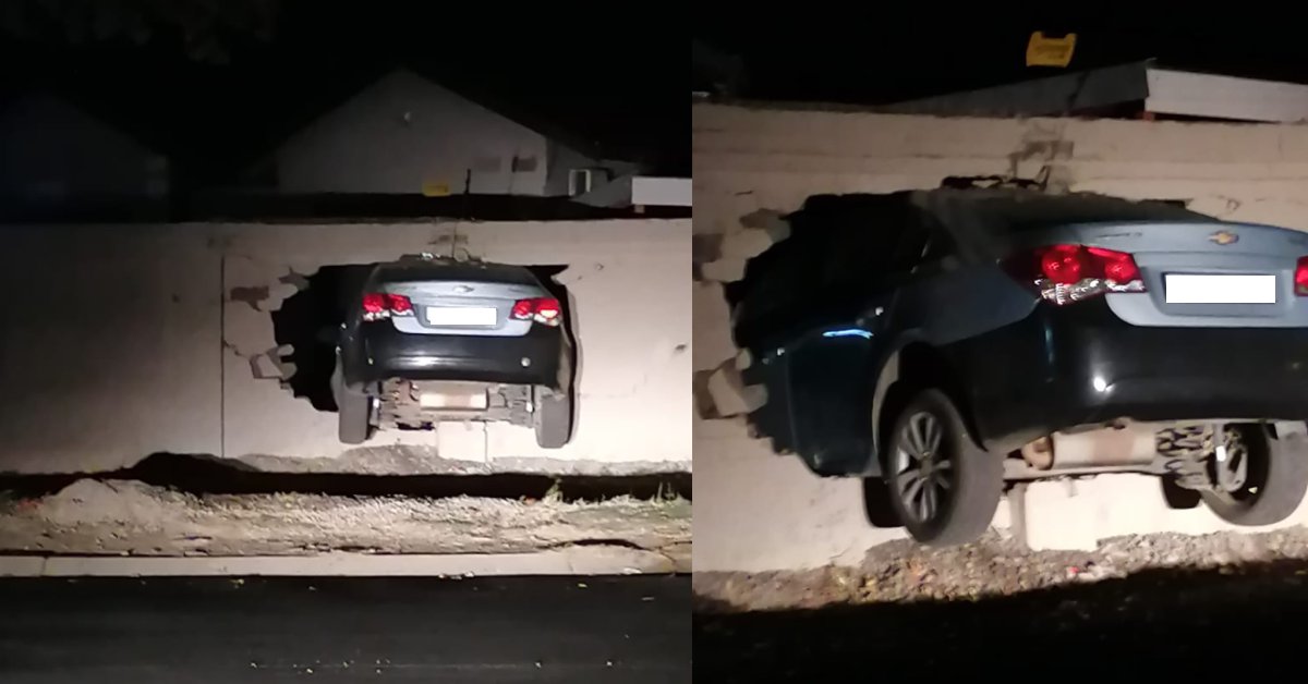 Motorist lodges car in property's wall