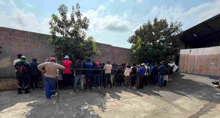Newcastle textile industry bust, people standing against a wall