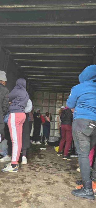 Newcastle textile industry bust, people standing in a truck