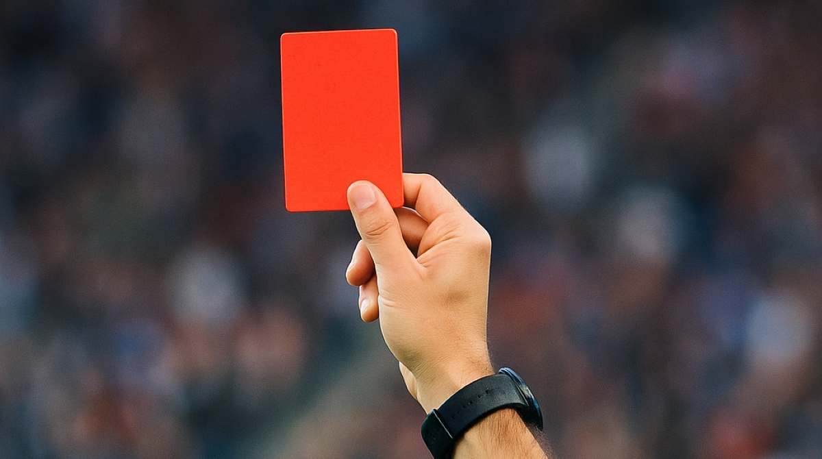 FIFA Punishes South Africa: Image shows a ref holding a red card in the air